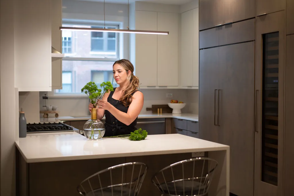 kitchen-herb-prep-ambiance Contemporary powder room with geometric wallpaper, sleek marble countertop, and contrasting elements. Elegant pendant lighting enhances the modern aesthetic.