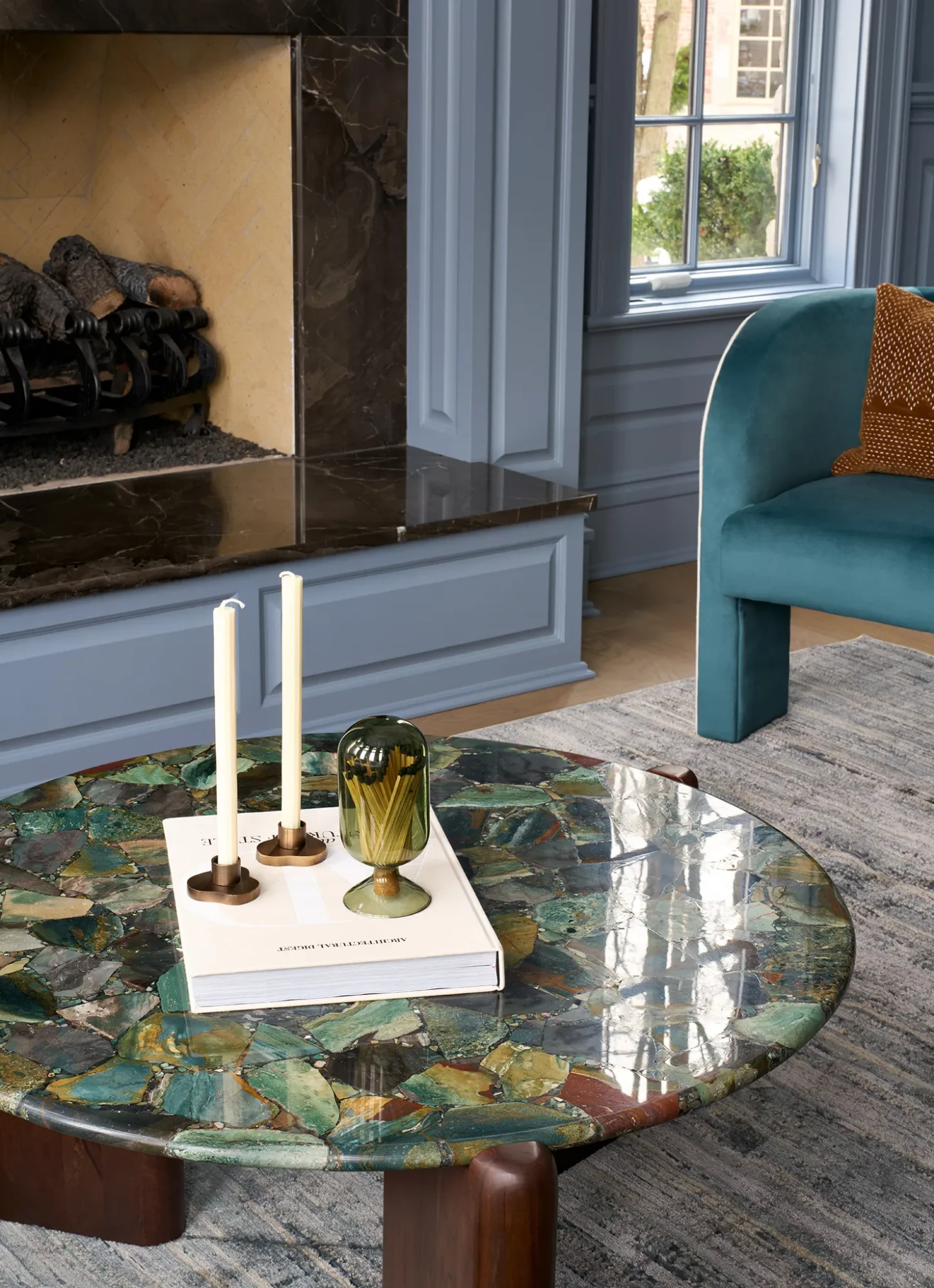 Contemporary living room featuring blue hues, luxurious textures, and elegant furnishings.