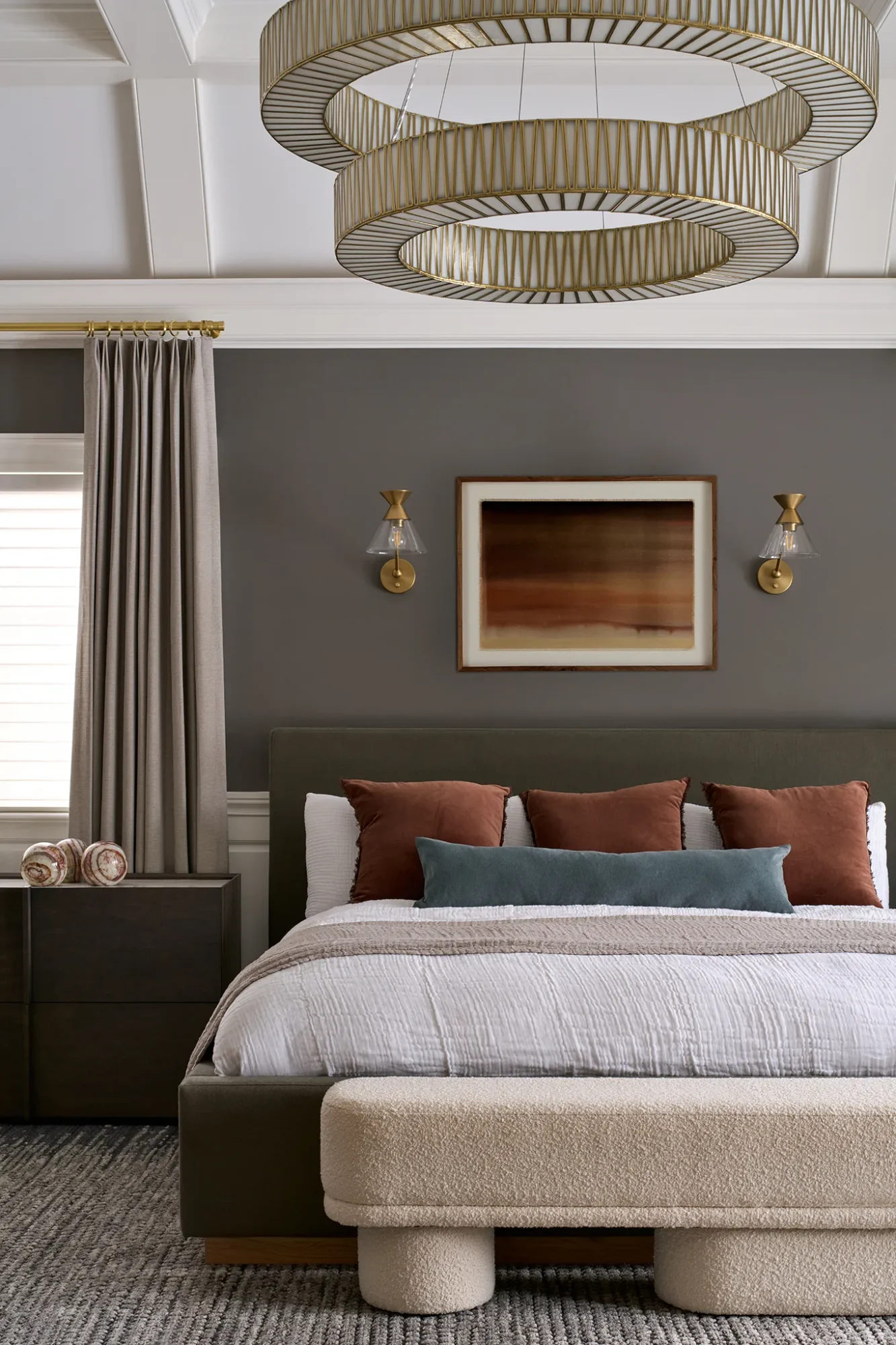 Modern bedroom with neutral palette, upholstered bed, and abstract art.