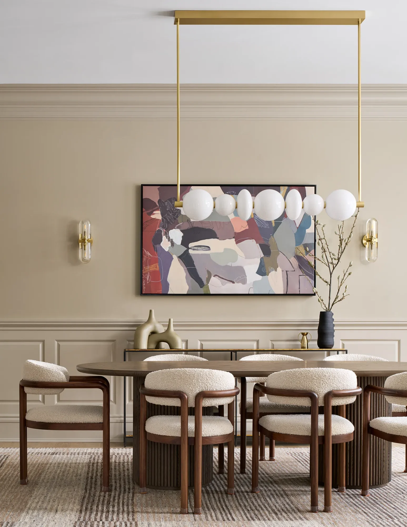 Sleek modern dining room with wood table, upholstered chairs, and gold accents.