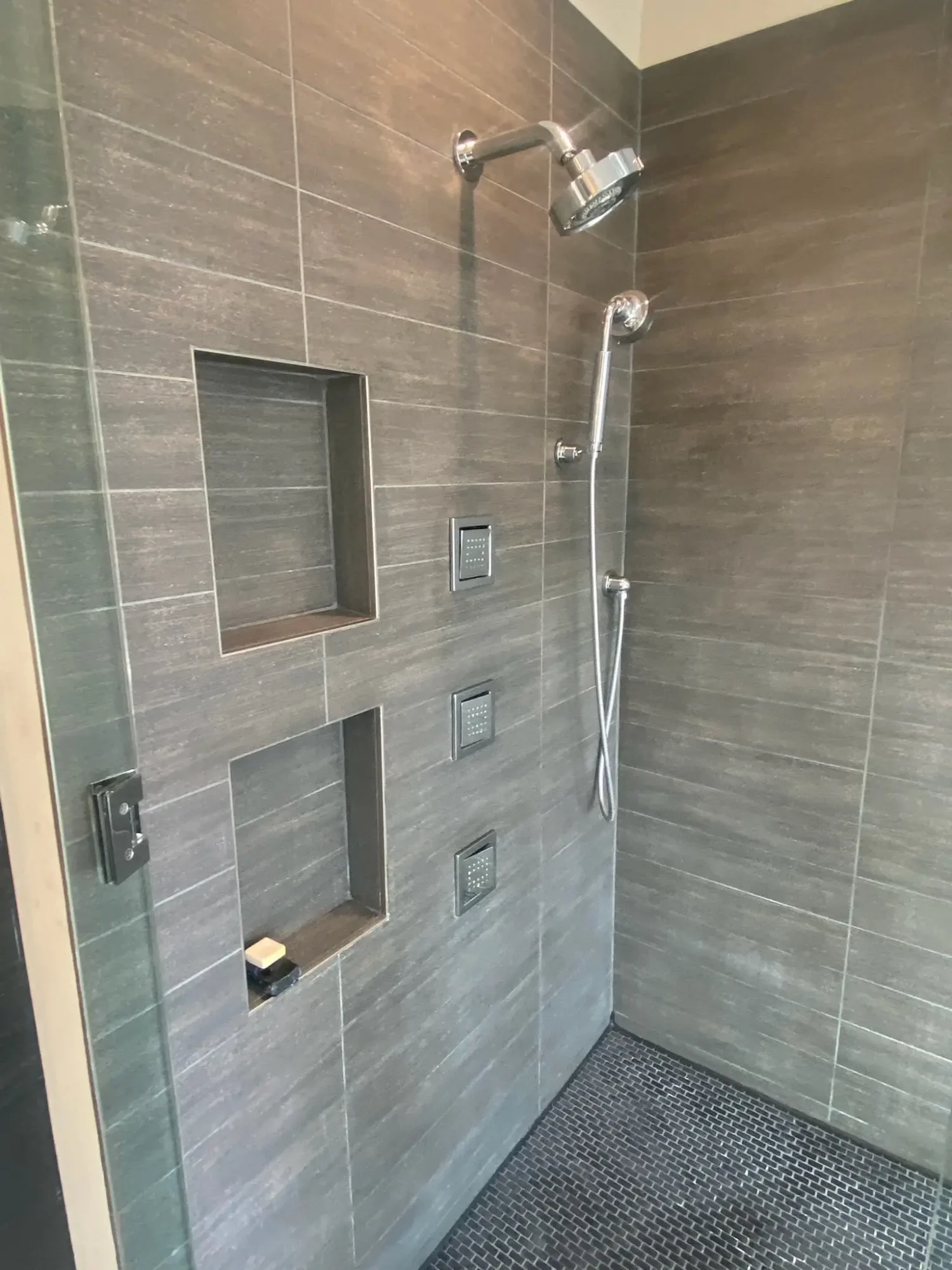 Material flat lay with Nemo mosaic tile samples, walnut, Dekton, and blue-gray paint chips for Bucktown bathroom design